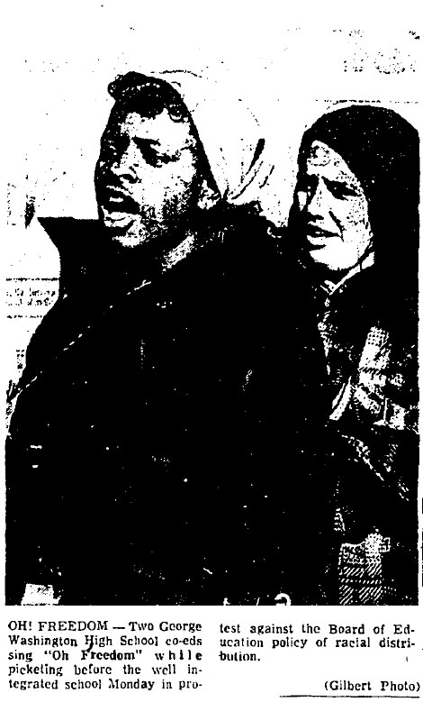 Two young people sing at a protest